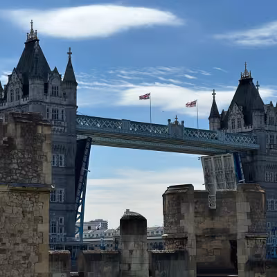 Tower Bridge in London with bascules raised, seen from historic stone ramparts