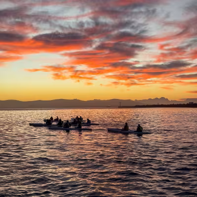 sunrise kayak with bright colorful skies and water