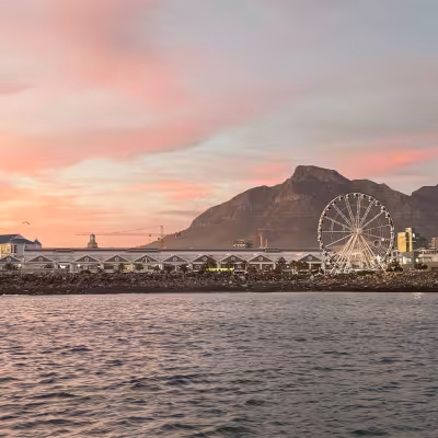 cape town waterfront at sunrise pink skies and ferris wheel