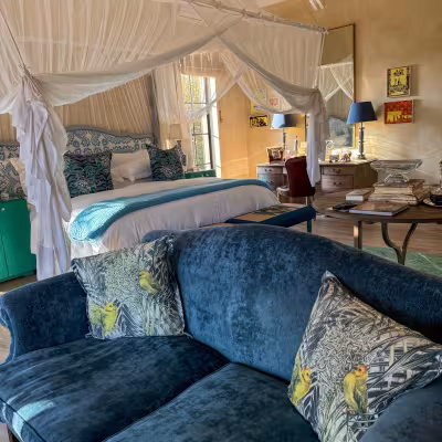 farmstead at Royal Malewane blue couch and canopy bed