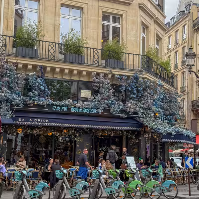 paris in summer street cafe people walking around and eating 