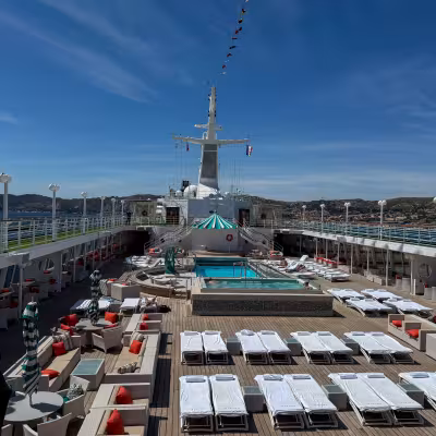 top check of Crystal Symphony deck chairs and pool with blue skies