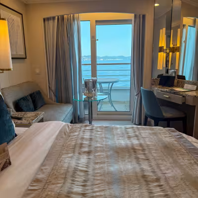 suite on crystal symphony with balcony curtains open