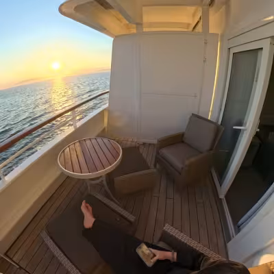 girl sitting on balcony on crystal symphony in a sapphire suite 