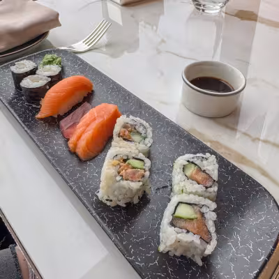 Fresh sushi and salmon rolls served during lunch aboard an Explora Journeys luxury cruise