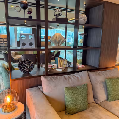 Contemporary lounge seating and decorative shelving aboard Explora Journeys