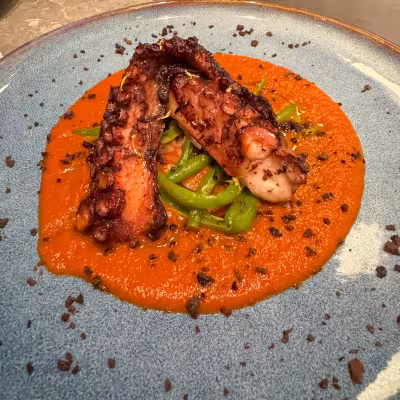 Grilled octopus with peppers and red sauce served at an Explora Journeys restaurant