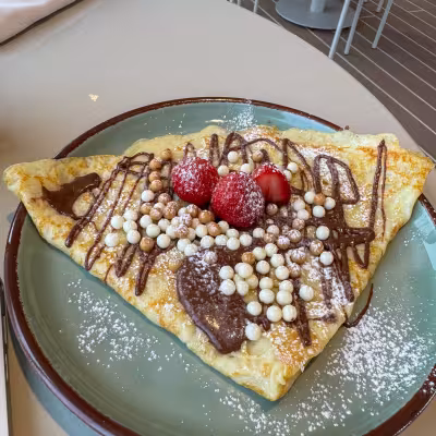 Nutella crepe with fresh strawberries and chocolate pearls served aboard Explora Journeys
