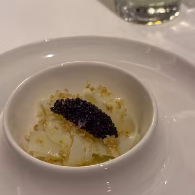 Elegant caviar-topped pasta dish served aboard Explora Journeys
