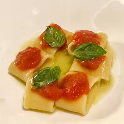 Italian pasta with tomato sauce and basil at an Explora Journeys specialty restaurant