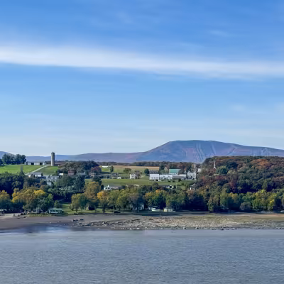 Scenic cruising day on Explora Journeys with fall colors and new England houses.