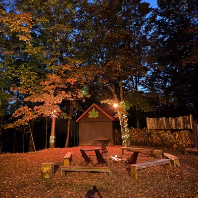 sugar shack at night with fall foliage colors