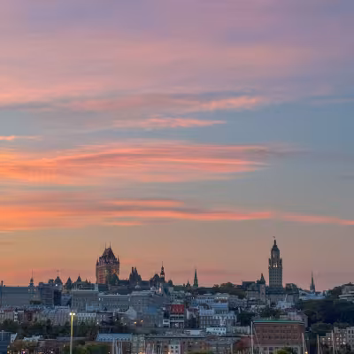pink cotton candy clouds behind the city