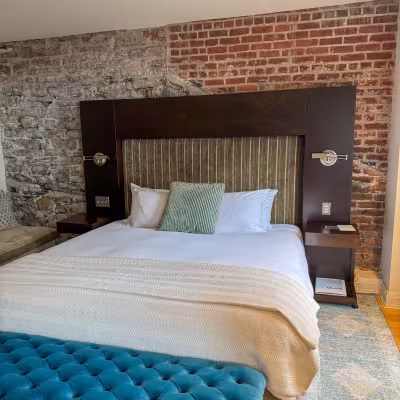 Auberge Saint Antoine room with brick aesthetic wall
