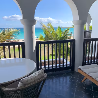 large balcony with table and chairs at four seasons anguilla