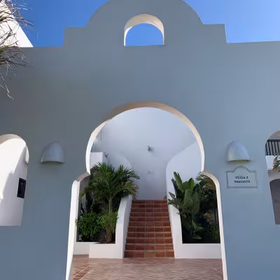 villa exterior with white washed building beachfront