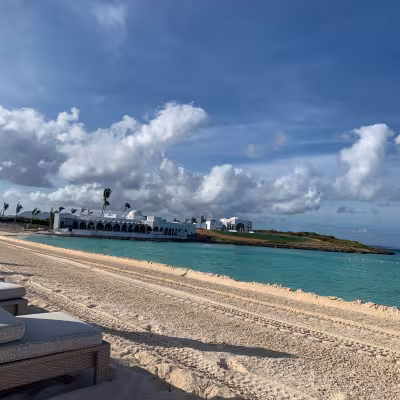 long stretch of white sand beach and clear water
