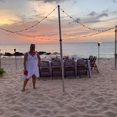 Private beachfront dinner under string lights at sunset at Belmond Cap Juluca, Anguilla