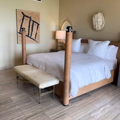 Elegant guest room with four-poster bed at Four Seasons Resort Anguilla