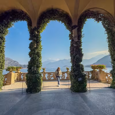 Ivy-covered arches framing panoramic views of Lake Como and surrounding mountains