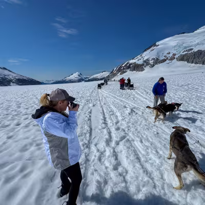 Musher and sled dog team on the Juneau icefield during a glacier dog sledding excursion