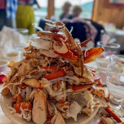 A towering plate of cracked Dungeness crab legs at the George Inlet Lodge crab feast, Ketchikan