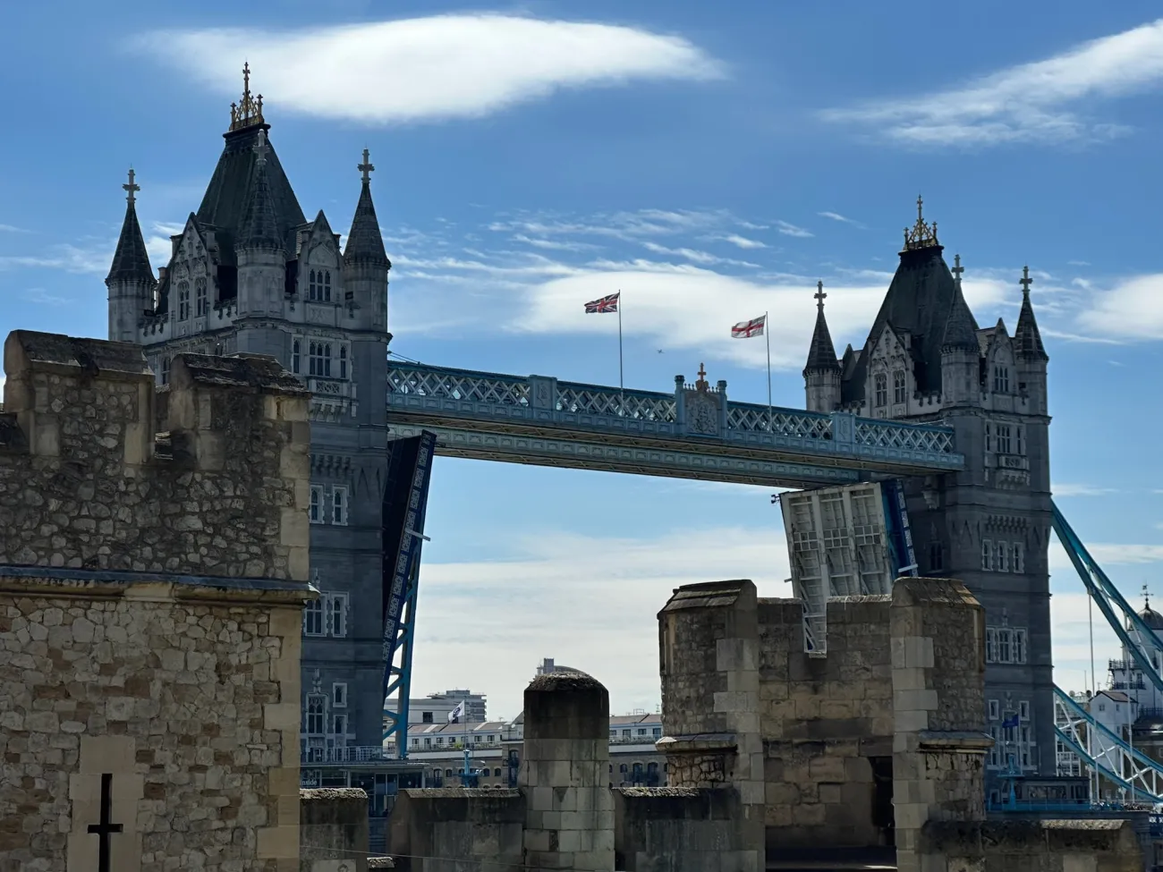 Tower Bridge in London with bascules raised, seen from historic stone ramparts