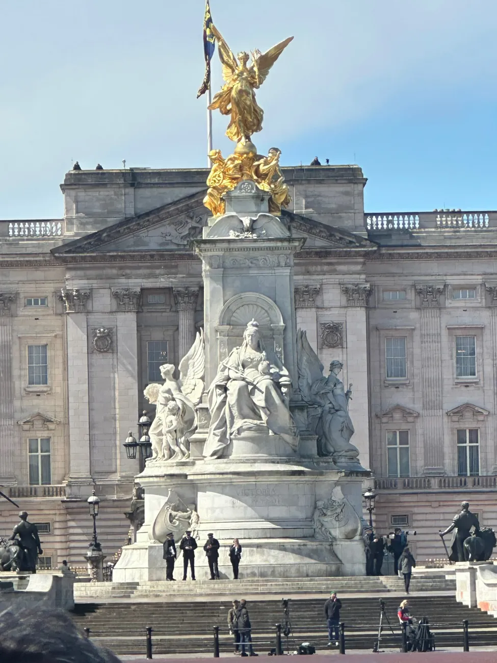 Victoria Memorial statue in front of Buckingham Palace in London under a blue sky