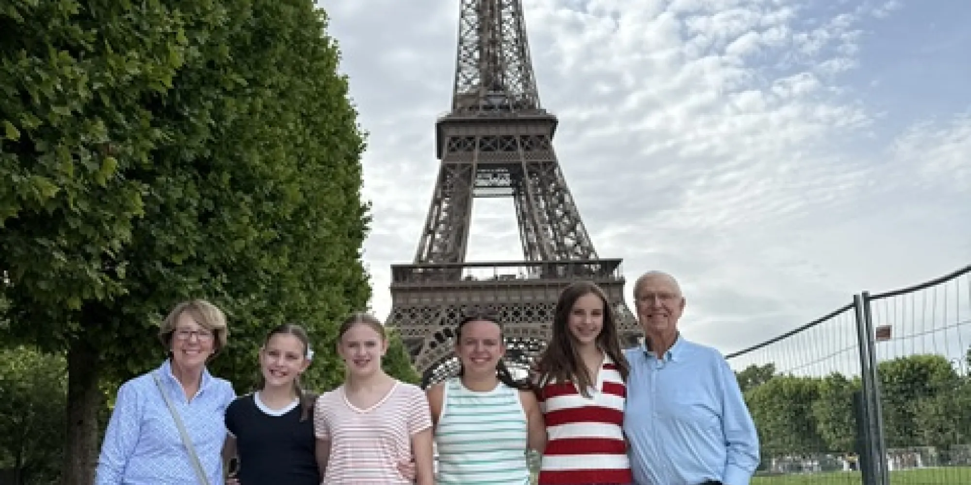 grandparents and grandchildren near the Eiffel tower